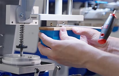 Operator adjusting a pad during setup