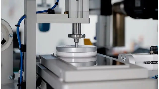Close-up view of a sealed ink cup mechanism within a TTN servo-driven pad printer, highlighting the precision engineering and clean ink delivery system for efficient industrial printing, distributed by Automark.
