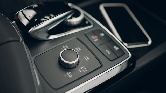 Automotive interior with precision-marked console controls, showcasing industrial printing equipment capabilities for high-detail branding and functional graphics by Automarkco.com.